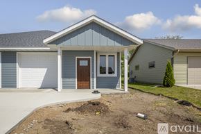 Saint Peter townhouse for rent - A house with a blue front and a brown door is for sale.
