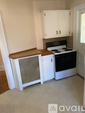 Kingston apartment for rent - A kitchen with a stove and cabinets.