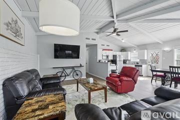 Richardson house for rent - A living room with a black leather couch and a wooden coffee table.