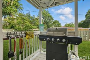 Richardson house for rent - A BBQ grill is on a covered patio with a caution sign attached to the fence.