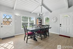 Richardson house for rent - A dining room with a table set for four and a ceiling fan.