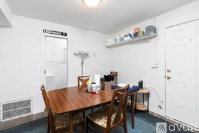 Charlottesville apartment for rent - A dining room with a wooden table and chairs.