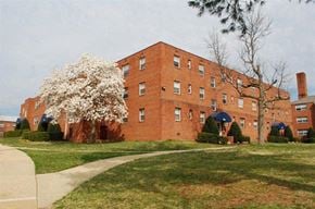 Falls Church apartment for rent - a brick building with a flowering tree in front of it