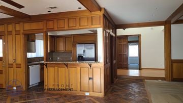 Lakewood apartment for rent - A kitchen with wooden cabinets and a logo on the floor.