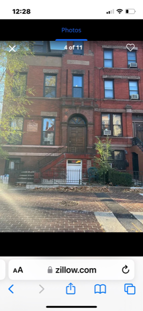 Jersey City apartment for rent - A red brick building with a white door and windows.