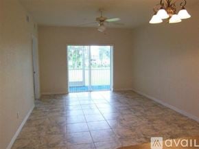 Port Charlotte apartment for rent - A room with tiled flooring and a ceiling fan.
