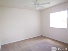 Port Charlotte apartment for rent - A room with a ceiling fan and a window letting in sunlight.