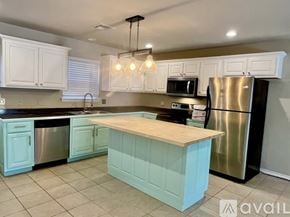 Eucha townhouse for rent - A house is situated on a hill with a parking lot in front of it.