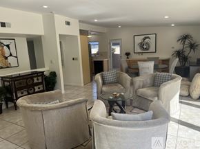 Indian Wells house for rent - A bedroom with a bed, pillows, a lamp, and a ceiling fan.