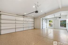 Indian Wells house for rent - A spacious garage with a white ceiling and a large window.