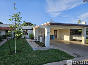 Phoenix townhouse for rent - A house with a white exterior and a brown roof is shown.