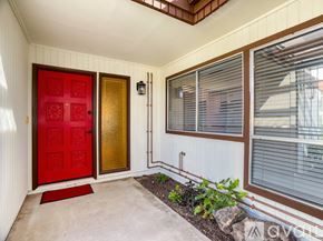 Phoenix townhouse for rent - A pool area with a table and chairs and a building in the background.