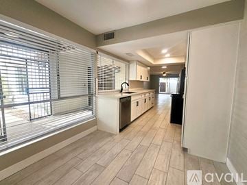 Phoenix townhouse for rent - A kitchen with a white counter and a black trash bin.