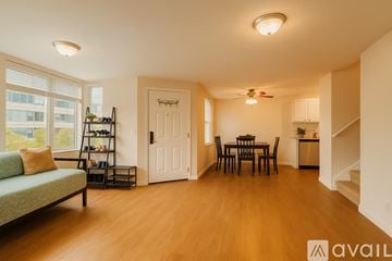 San Francisco apartment for rent - A living room with a green couch and a dining table.