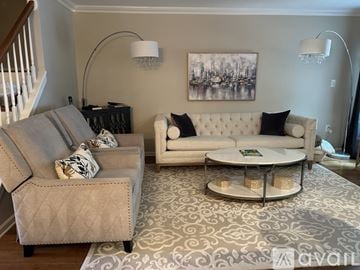 Holmdel house for rent - A living room with a grey couch and a white couch.