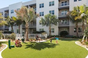 Sarasota apartment for rent - A large white building with a pool in the middle of it.