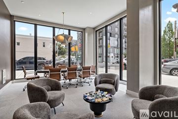 Brooklyn apartment for rent - A living room with grey chairs and a coffee table with a bowl of candy on it.