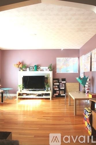 Newton apartment for rent - A living room with a television and a table.