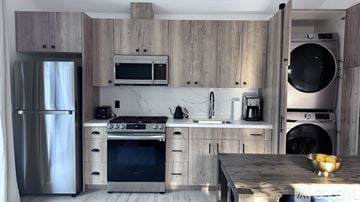 Los Angeles house for rent - A modern kitchen with wooden cabinets and stainless steel appliances.