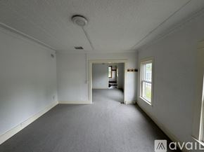 North Creek apartment for rent - A spacious room with a carpeted floor and white walls.