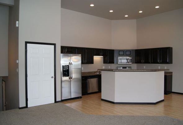 West Fargo townhouse for rent - an empty kitchen with a refrigerator and a sink