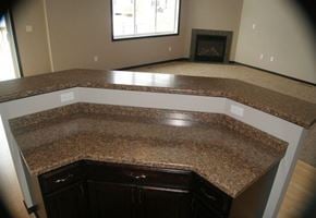 West Fargo townhouse for rent - an empty kitchen with a counter top and a fireplace