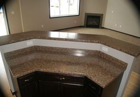 West Fargo townhouse for rent - an empty kitchen with a counter top and a fireplace