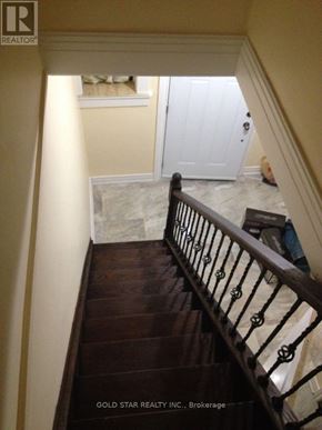 Oshawa (Central) house for rent - A staircase with a dark wood finish and a metal railing.