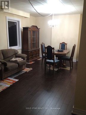 Oshawa (Central) house for rent - A living room with a couch, chairs, and a cabinet.