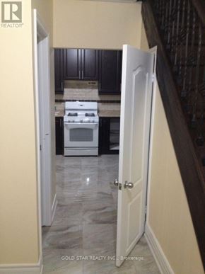 Oshawa (Central) house for rent - A white door is open to a kitchen.