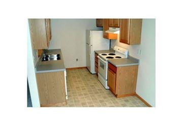West Fargo townhouse for rent - a small kitchen with a stove and a refrigerator