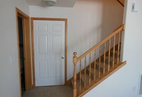 West Fargo townhouse for rent - a staircase in a house with a white door