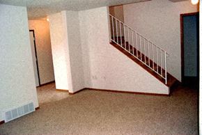 Moorhead townhouse for rent - an empty living room with a staircase