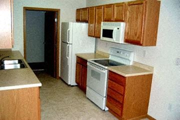 Moorhead townhouse for rent - a kitchen with a stove microwave and refrigerator