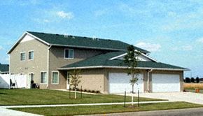 Moorhead townhouse for rent - a house with a garage and a tree in front of it