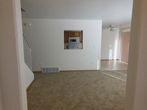Moorhead townhouse for rent - an empty living room with a microwave in the wall