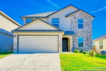 Bulverde house for rent - A two-story house with a garage door and a driveway.