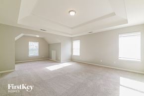 Newnan house for rent - A spacious room with a carpeted floor and a skylight.