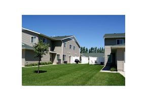 Moorhead townhouse for rent - a green lawn in front of a row of houses