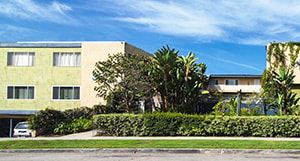 Los Angeles apartment for rent - A building with a white car parked in front.