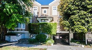 Sherman Oaks apartment for rent - A brown and white building with a gate in front.
