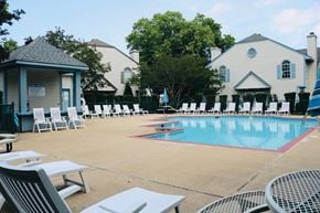 Virginia Beach house for rent - A pool area with a small building and chairs.