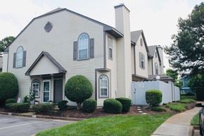 Virginia Beach house for rent - A house with a grey facade and a black door.