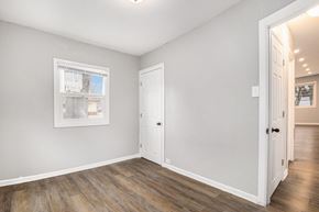 Gary house for rent - A room with a white door and a window with a white frame.