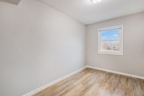 Gary house for rent - A room with a window and a picture on the wall.