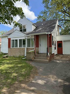 Wausau apartment for rent - A house with a red door and a white garage door.