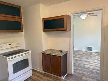 Wausau apartment for rent - A kitchen with a white stove and a wooden cabinet.