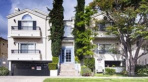 Sherman Oaks apartment for rent - A white two-story building with a black gate in front.