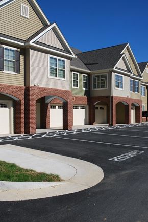 Waynesboro apartment for rent - an empty parking lot in front of a row of houses