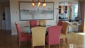 Longboat Key apartment for rent - A dining room with a large painting on the wall and a chandelier hanging above the table.